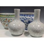 A Chinese blue and white jardiniere, a Chinese jardiniere decorated with fruit and a pair of crackle