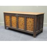 A 19th century carved and inlaid oak coffer encorporating earlier parts 69 x 144 x 55cm