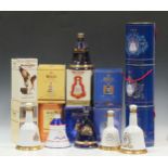A collection of fourteen Bells commemorative whiskey decanters, to include: 1990 - The Birth of