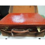 A crocodile skin vanity case by JW Benson with canvas outer cover, containing three silver topped