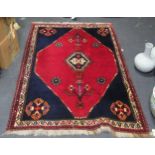 A red ground woolen rug 174 x 126cm