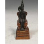 A bronze cast figure of an Egyptian pharoah, probably early 20th century, set in a wooden throne