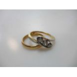 A three stone diamond ring, unmarked, tested as 18ct gold with platinum settings weight 3.1g,