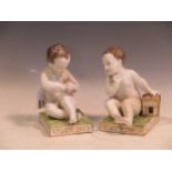A pair of Meissen bookends, modelled as seated cherubs, the rectangular bases mounted with cages,