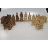 An early 20th century Chinese ivory chess set, one side stained walnut brown, the other natural, 8.