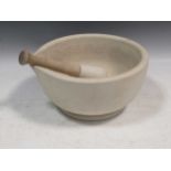 A large pestle and mortar, 15cm high and 30cm diameter