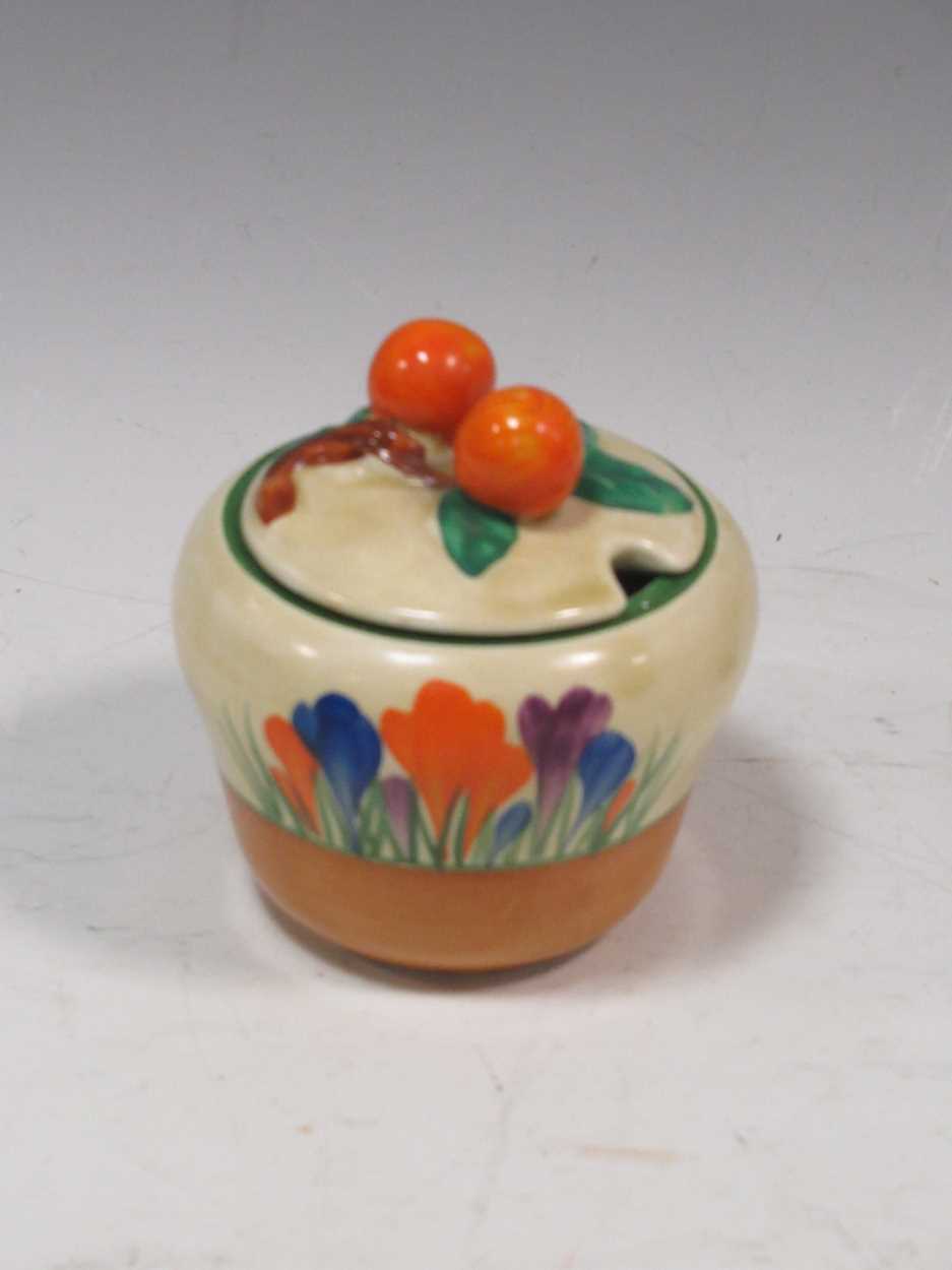 Clarice Cliff - a 'Crocus' pattern conserve pot and lidCondition report: Generally good condition.