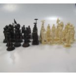 A 19th century Indian provincial ivory chess set, one side stained purple, this bishop or wazier