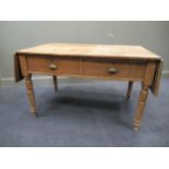 A pine drop leaf table with two drawers on turned legs 76 x 124 x 76cm