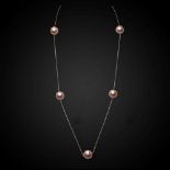 A rose coloured chain with scattered Edison peach coloured freshwater cultured pearls,