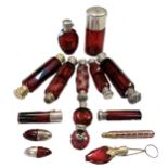 A collection of Victorian and later red glass scent bottles,