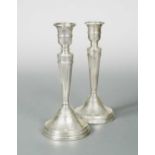 A pair of George V silver candlesticks,