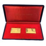 A cased pair of 18ct gold replica postage stamps,