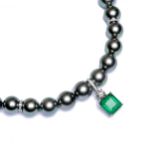 A single row of peacock coloured Tahitian cultured pearls with an emerald and diamond pendant,