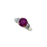 A ruby ring with diamond set shoulders,