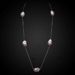 A rose coloured chain with scattered freshwater cultured baroque pearls,