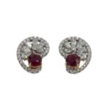 A pair of ruby and diamond swirl ear studs,