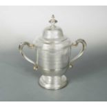 A George V silver two handled trophy cup and cover,