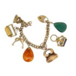 A late 20th century charm bracelet with assorted charms,