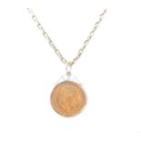 A 20 French Franc gold coin and chain,