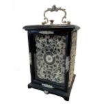 A Victorian carriage clock with silver embellishments,