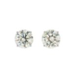 A pair of diamond solitaire ear studs,