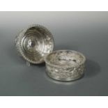 An impressive and heavy pair of William IV cast silver bottle coasters,