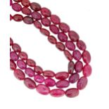A three row carved ruby bead necklace,