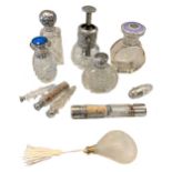 An Edward VII silver topped glass atomiser and a collection of clear glass scent bottles,