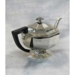 A George V silver teapot with hot water jug en suite,