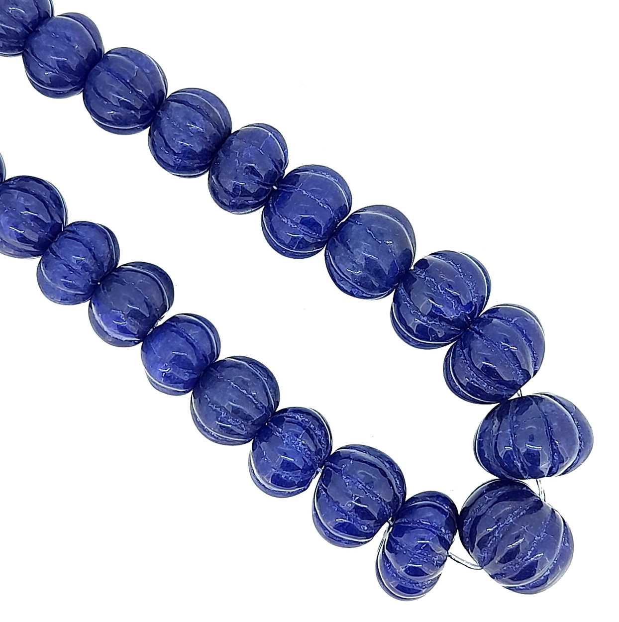 A single row of carved sapphire beads,