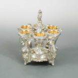 A George III silver egg cruet for 6 with additional spoons,