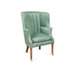 A George III barrel back wing armchair,