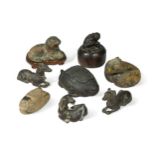 A group of eight Chinese bronze scroll weights,