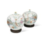 A pair of Chinese famille rose porcelain ovoid vases and covers, late Qing Dynasty,