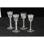 Four mid 18th century engraved wine glasses,