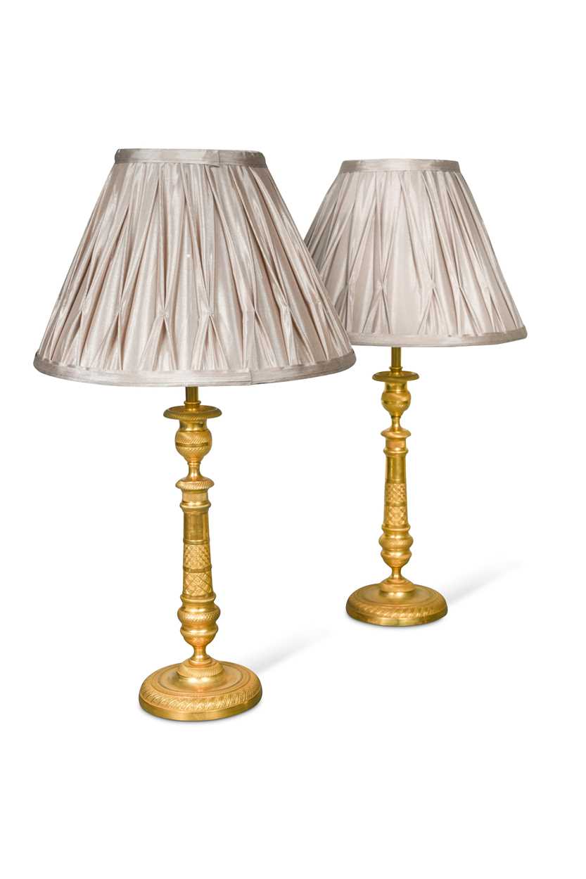 A pair of Regency engine turned ormolu candlestick lamps, circa 1820,