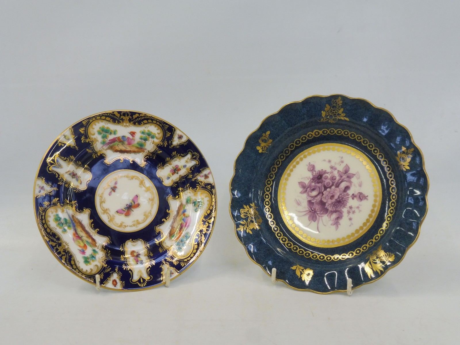 A Royal Worcester bowl, blue and gilded border with central mauve floral spray, 7 3/4" diameter,