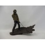 A well detailed bronze sculpture in the form of a golfer hitting a ball out of a bunker, signed Mark