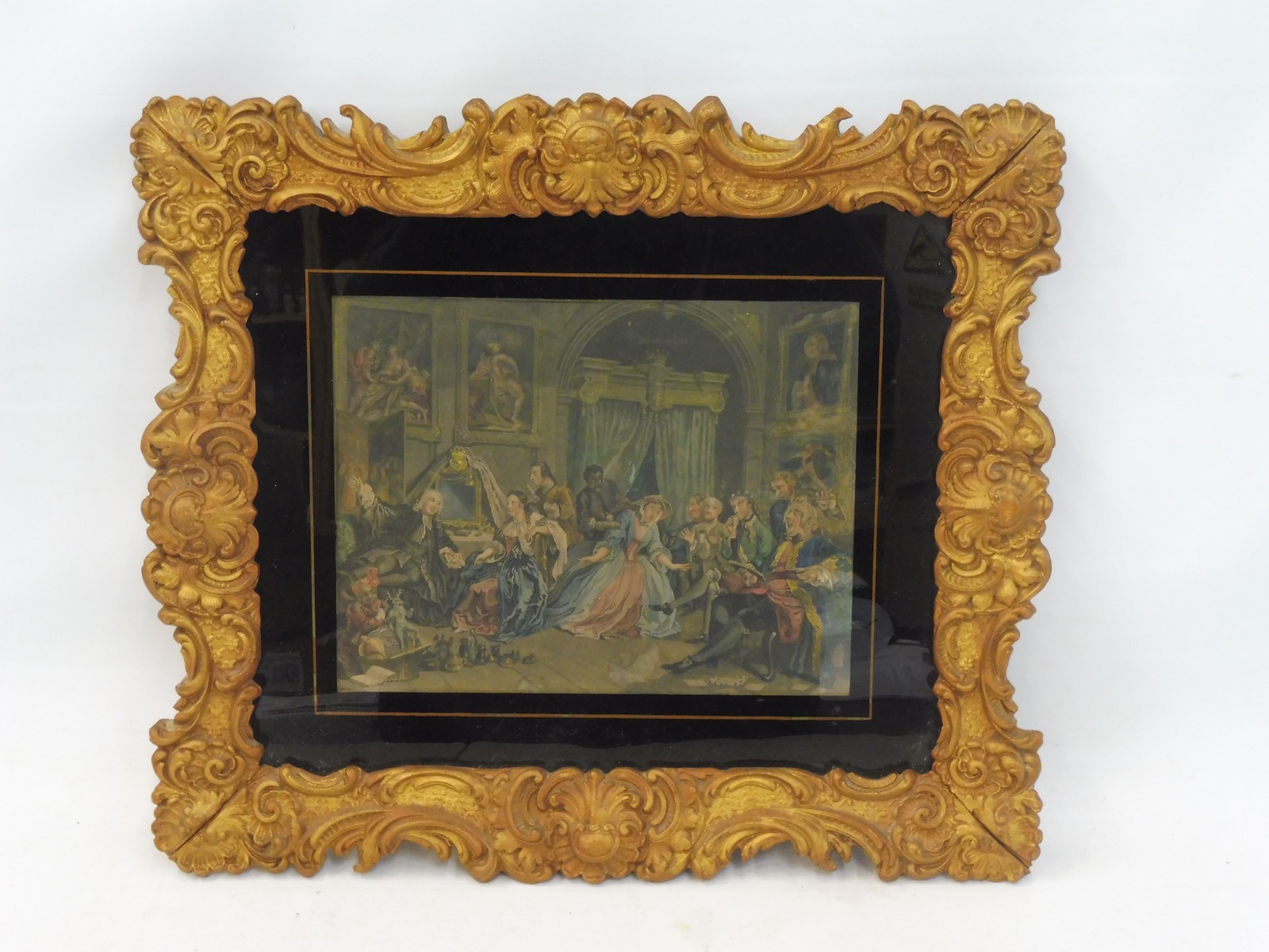 A gilt framed interior scene print set within a glass mount, 16 x 14".