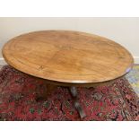 A Victorian walnut oval loo table with boxwood line inlay, raised on four swept supports, the top