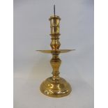 A 17th Century Dutch West Indies brass pricket candlestick with a broad mid drip pan, 11" long.