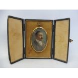 A 9ct gold backed oval portriat miniature of a gentleman set within a leather case, retailed by