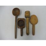 A quantity of 19th Century treen kitchen implements including a fruitwood butter stamp.