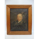 A Georgian oil portrait bust of a gentleman in a burr maple frame.