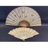 An ivory 11 section fan inset with reflective discs plus one other.