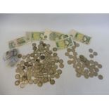 A selection of coins including approx. 99 pre-1948 silver shillings, also some bank notes.