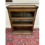 An oak Globe Wernicke style three section stacking bookcase with lift up glass doors, 34 1/2" w x 44