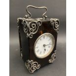 A rare 19th Century tortoiseshell and silver mounted carriage clock, with scrolled corner mounts,