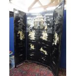 An ebonised Oriental four fold screen, highly decorated to one side with mother of pearl and